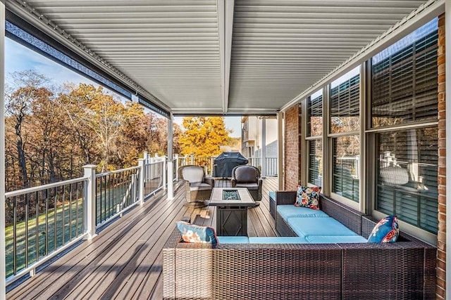 deck featuring grilling area and an outdoor fire pit