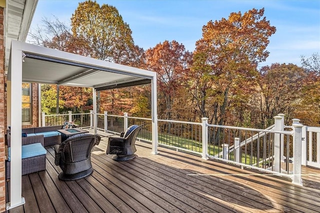 wooden terrace with an outdoor living space with a fire pit