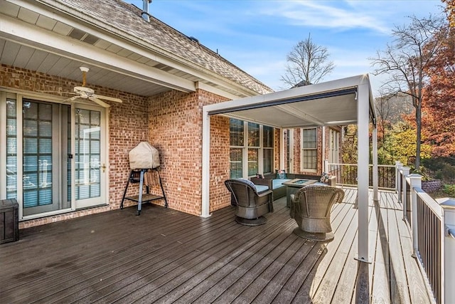 deck with an outdoor living space and ceiling fan