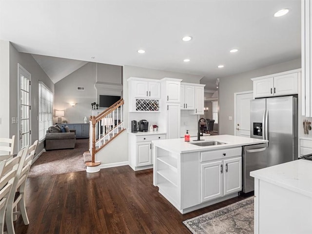 kitchen featuring white cabinetry, sink, a kitchen island with sink, and appliances with stainless steel finishes