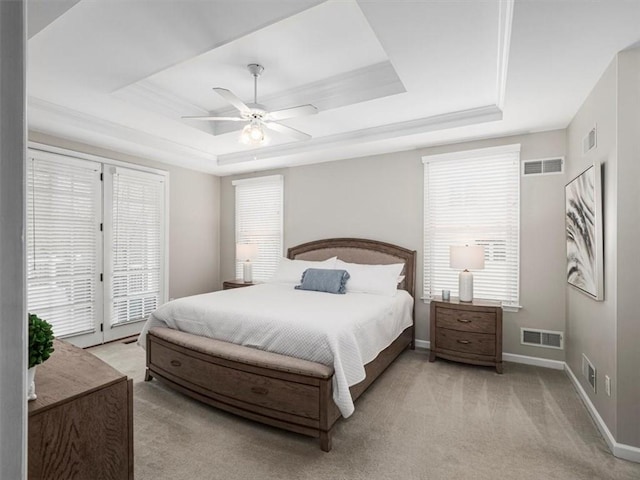 carpeted bedroom featuring a tray ceiling, access to exterior, ceiling fan, and french doors