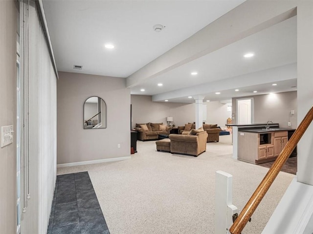 carpeted living room with sink