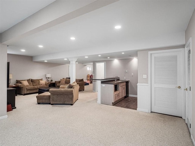 living room with dark colored carpet and sink