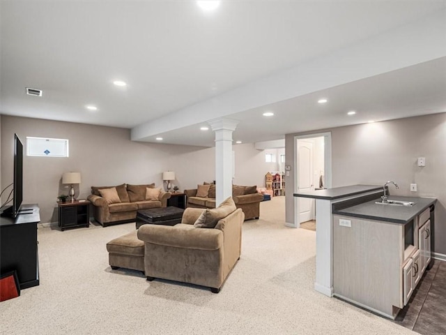 carpeted living room featuring sink