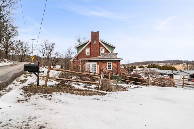 exterior space featuring a chimney and fence