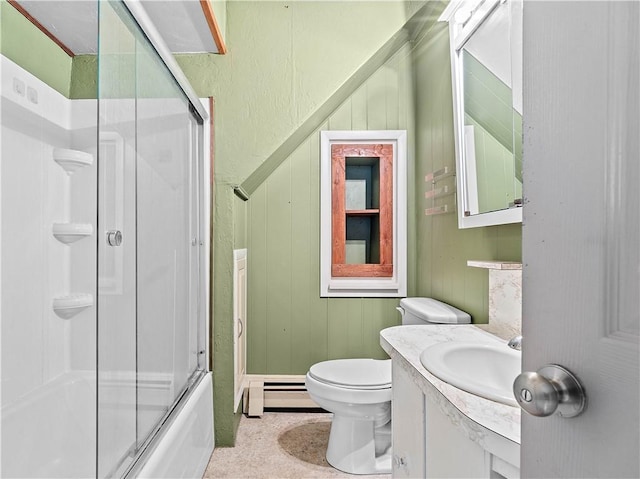 bathroom featuring a baseboard heating unit, toilet, shower / bath combination with glass door, and vanity