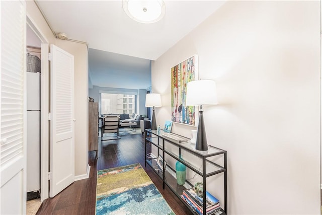 corridor with dark hardwood / wood-style flooring