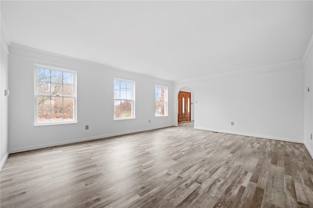 unfurnished living room with crown molding and light hardwood / wood-style flooring