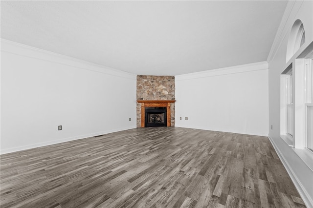 unfurnished living room featuring ornamental molding, a fireplace, and wood-type flooring