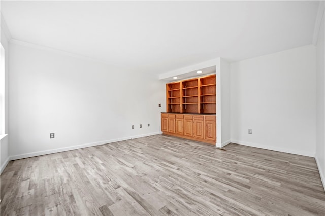 unfurnished living room with light hardwood / wood-style floors, built in features, and ornamental molding