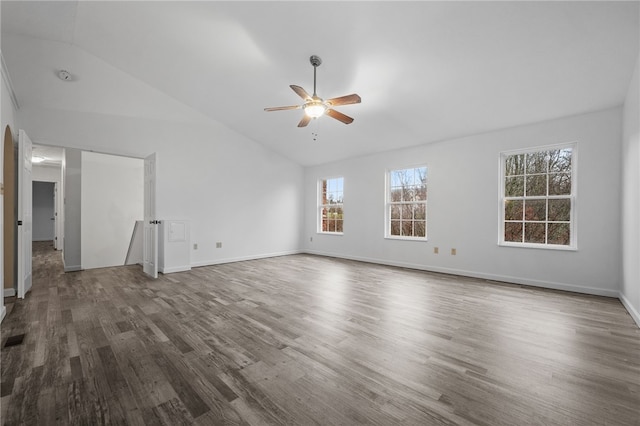 unfurnished living room with ceiling fan, dark wood-type flooring, and vaulted ceiling