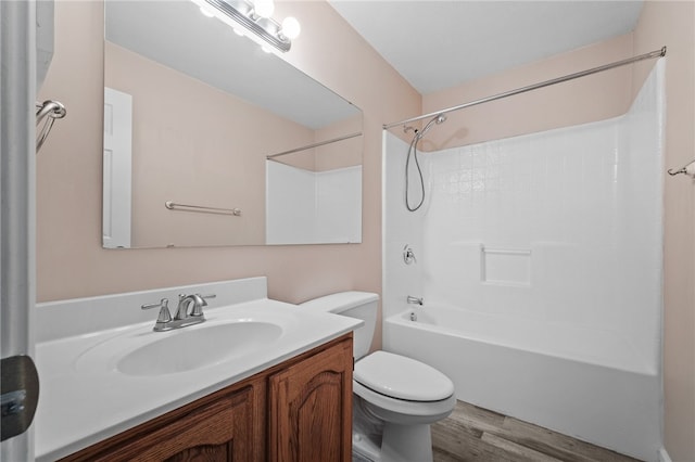 full bathroom with wood-type flooring, vanity, toilet, and shower / washtub combination