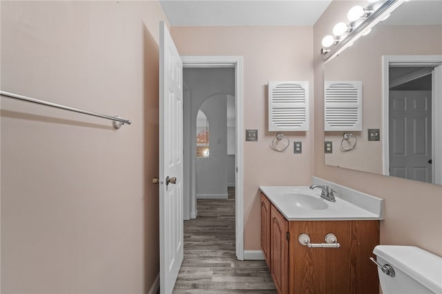 bathroom featuring hardwood / wood-style floors, vanity, and toilet