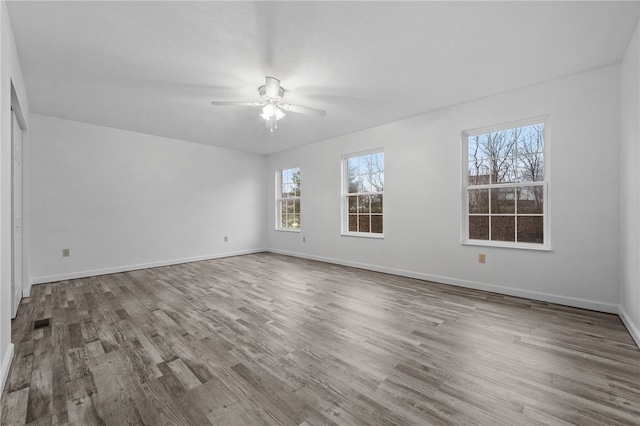 unfurnished room with ceiling fan and hardwood / wood-style floors