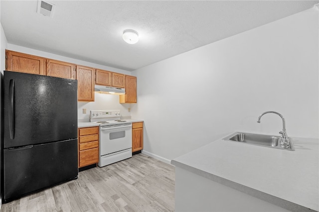 kitchen featuring black refrigerator, white electric range, sink, light hardwood / wood-style flooring, and a textured ceiling