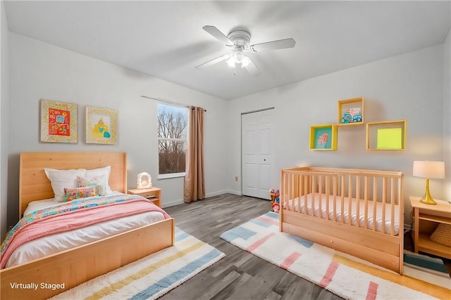 bedroom with ceiling fan, hardwood / wood-style floors, and a closet