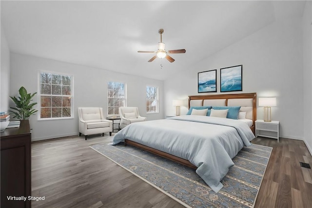 bedroom with vaulted ceiling, dark wood-type flooring, and ceiling fan