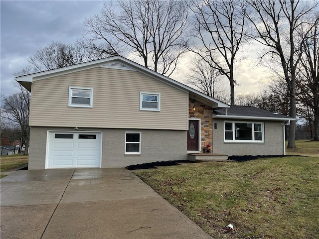 tri-level home featuring a lawn and a garage