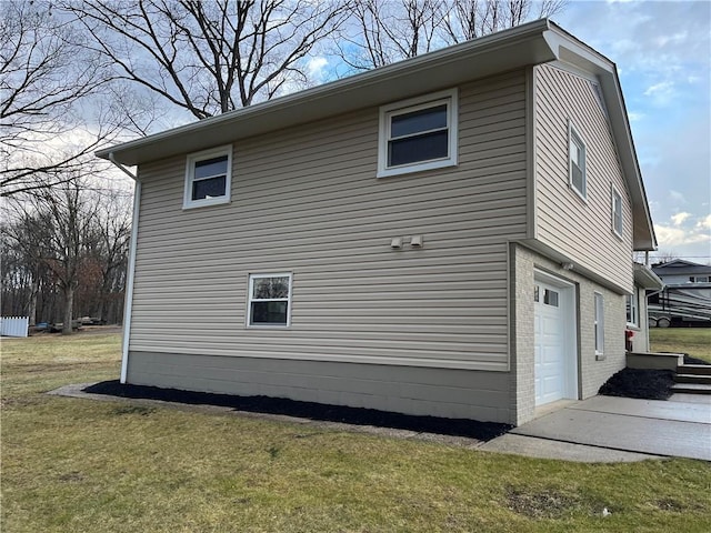 view of home's exterior featuring a garage and a yard