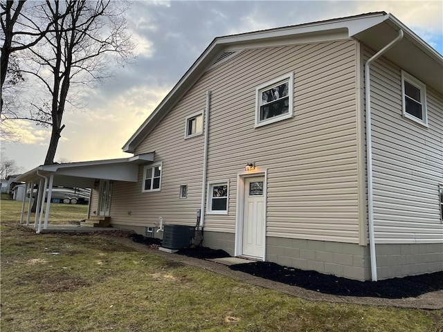 rear view of house with a yard and central AC