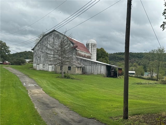 view of property exterior featuring a yard and an outdoor structure