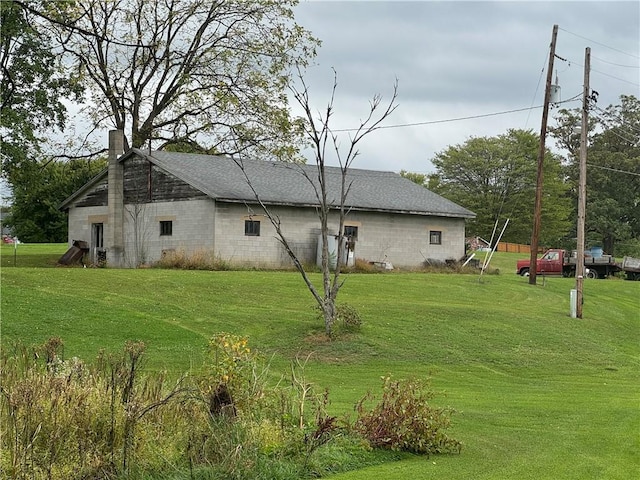 view of side of property with a lawn