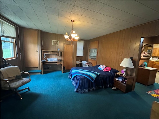 carpeted bedroom with wood walls and an inviting chandelier