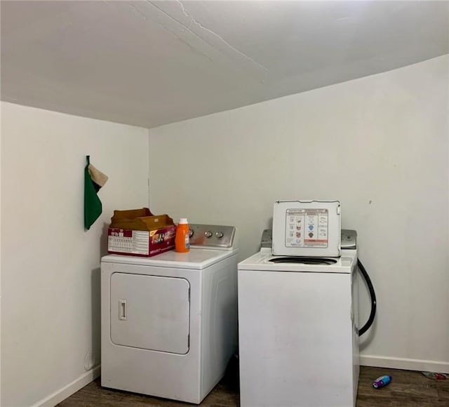 laundry area featuring independent washer and dryer and dark wood-type flooring