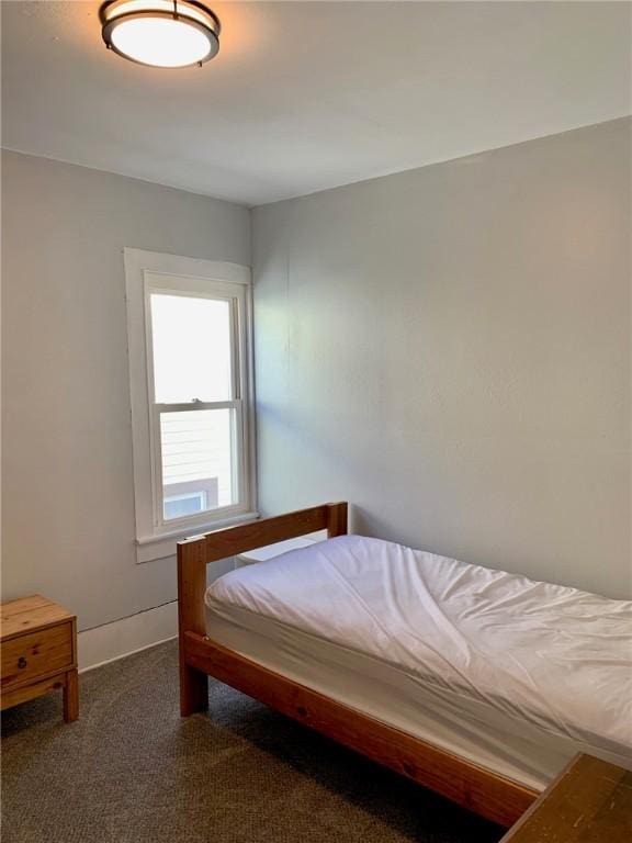 bedroom featuring dark carpet