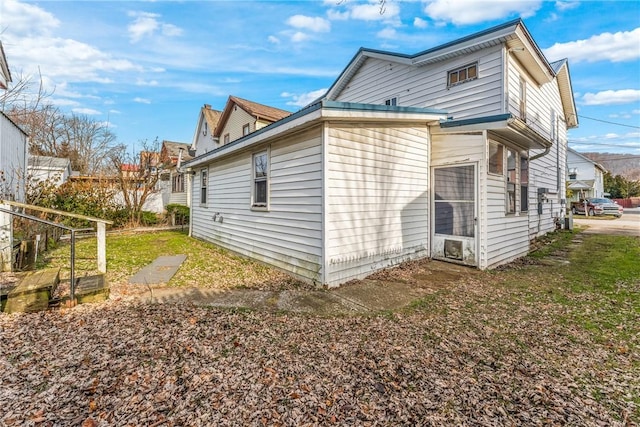 view of property exterior with a lawn