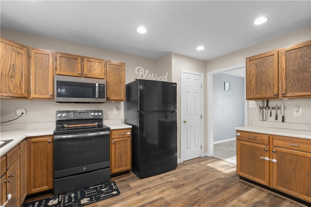 kitchen with wood-type flooring and appliances with stainless steel finishes