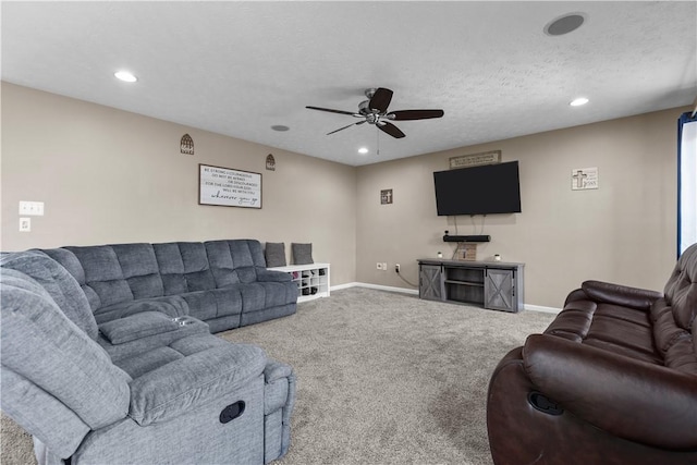 carpeted living room with ceiling fan and a textured ceiling