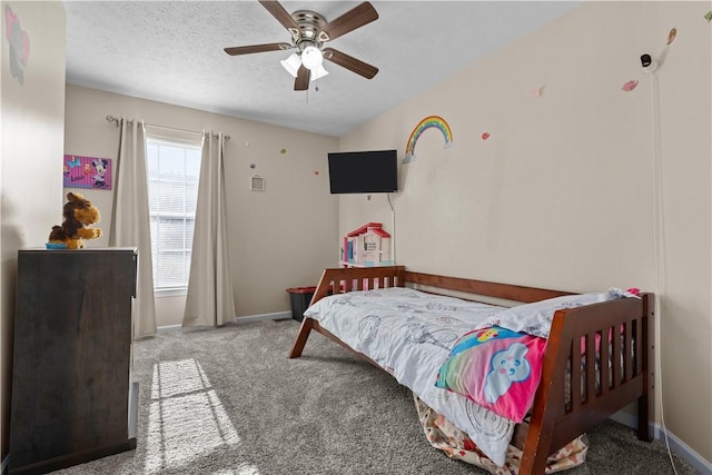 bedroom featuring carpet, a textured ceiling, and ceiling fan