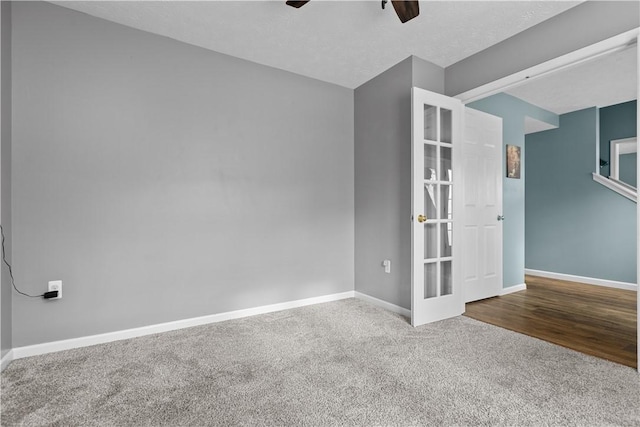 spare room featuring ceiling fan, carpet, and a textured ceiling