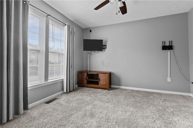 interior space with ceiling fan and light carpet