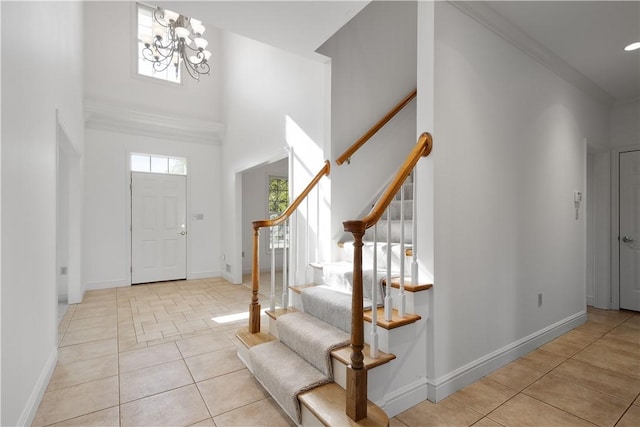 tiled foyer with a towering ceiling and an inviting chandelier