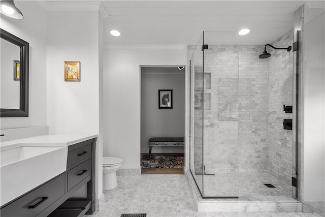 bathroom featuring vanity, ornamental molding, an enclosed shower, and toilet