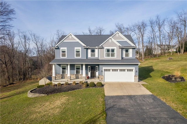 craftsman-style home featuring a porch, a front yard, and a garage