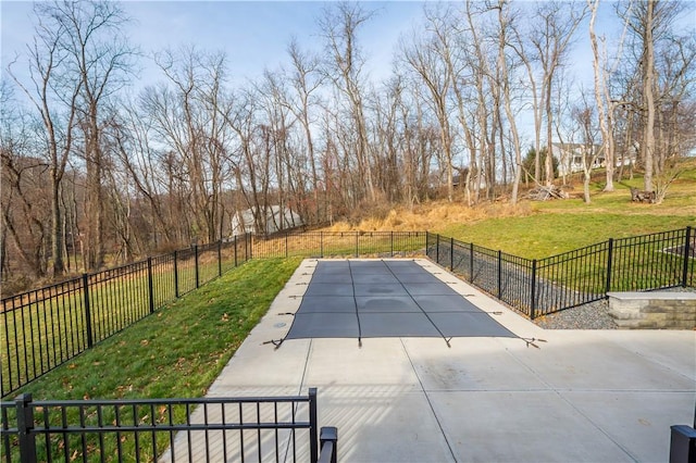 view of pool with a yard and a patio