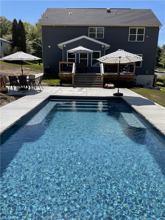 view of swimming pool with a patio area and a deck