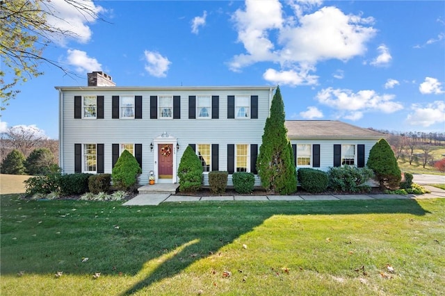 colonial-style house with a front yard