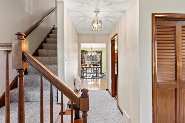 interior space featuring a chandelier and carpet floors