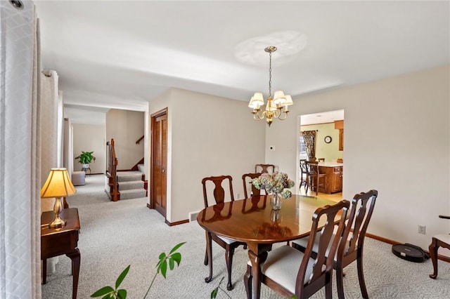 dining area featuring a notable chandelier and light colored carpet