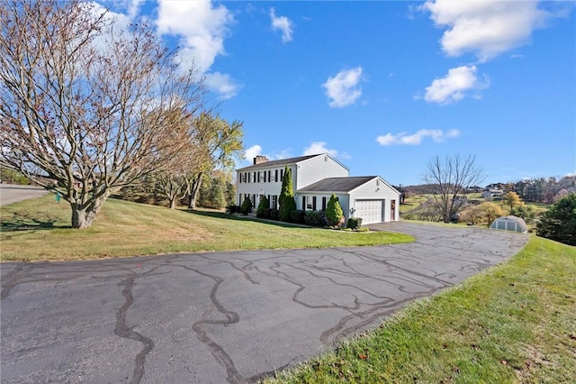 view of front of house featuring a garage and a front yard