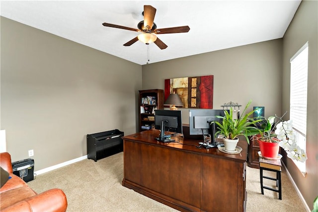 office with a wealth of natural light, ceiling fan, and light colored carpet