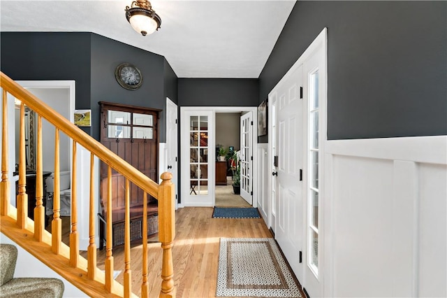 foyer entrance with wood-type flooring and french doors