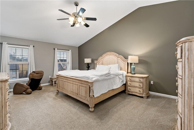 bedroom with ceiling fan, light colored carpet, and vaulted ceiling