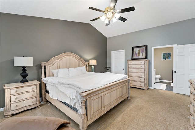 carpeted bedroom with connected bathroom, ceiling fan, and vaulted ceiling