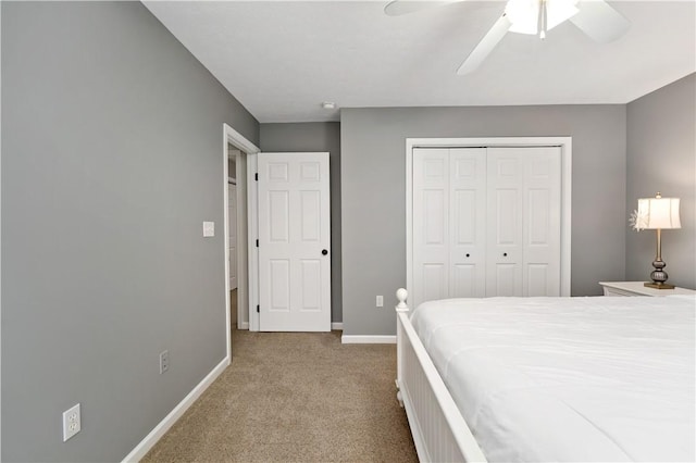 carpeted bedroom with ceiling fan and a closet