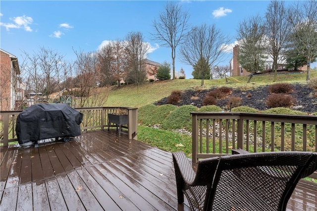 wooden terrace featuring a grill